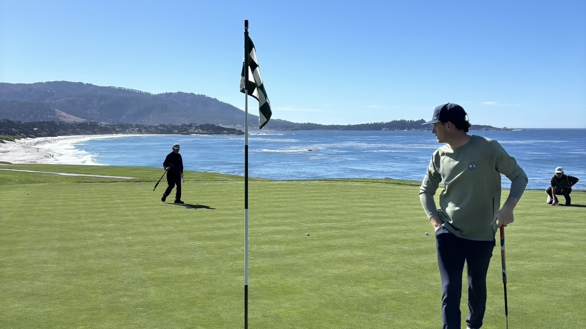 On-course golf playing lesson with Casey Harty demonstrating distance putting technique.